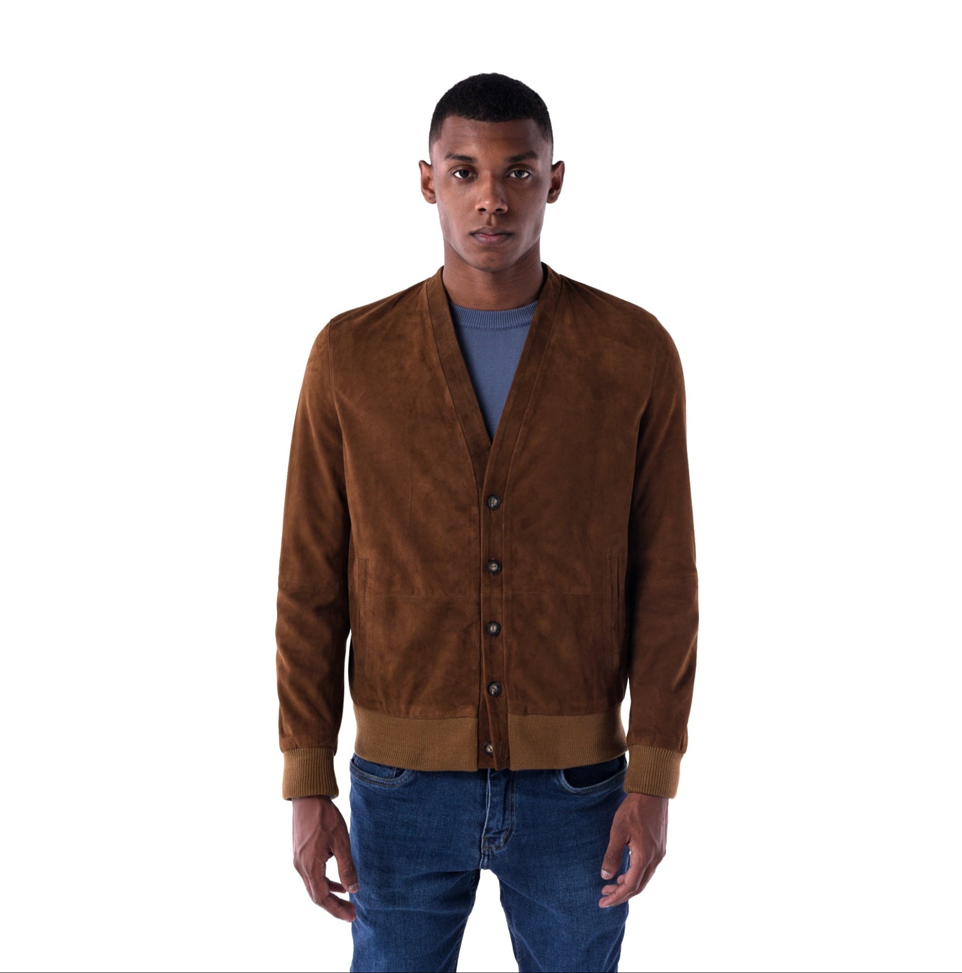 Man wearing a brown suede jacket and blue jeans on a white background