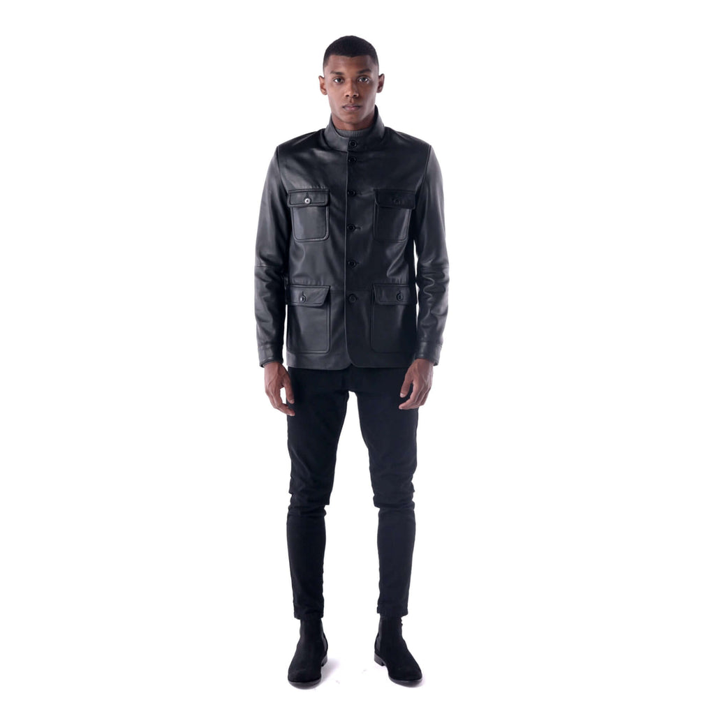 Man wearing a black leather jacket and pants on a white background