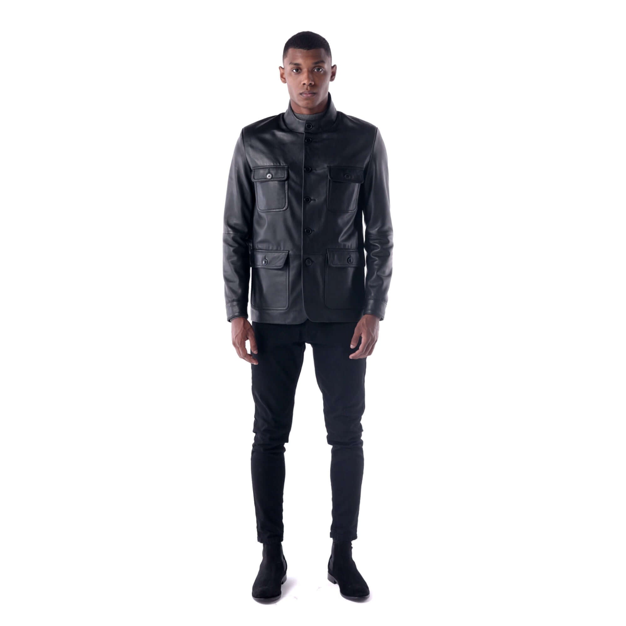 Man wearing a black leather jacket and pants on a white background