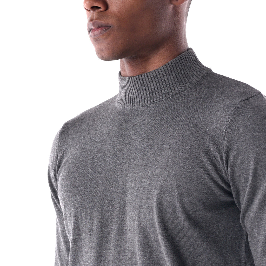 Gray turtleneck sweater worn by a person on a white background