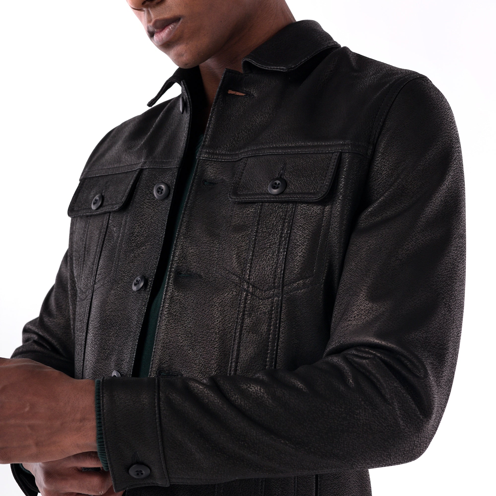 Black leather jacket worn by a person on a white background