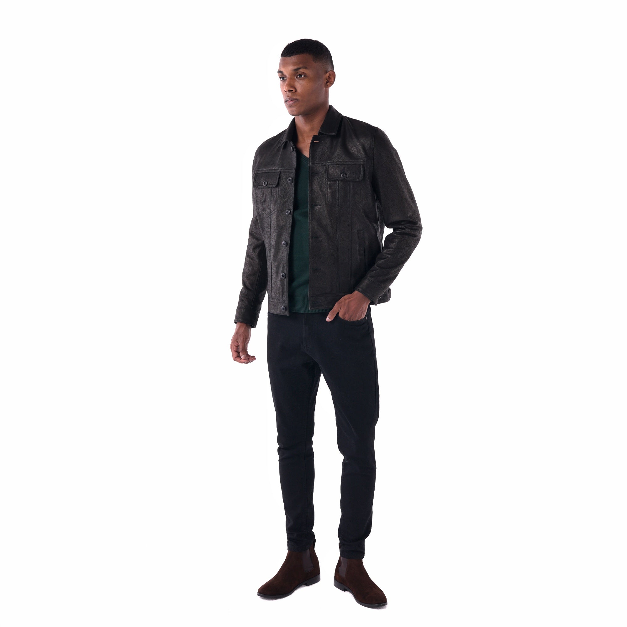 Man wearing a black denim jacket and dark jeans on a white background