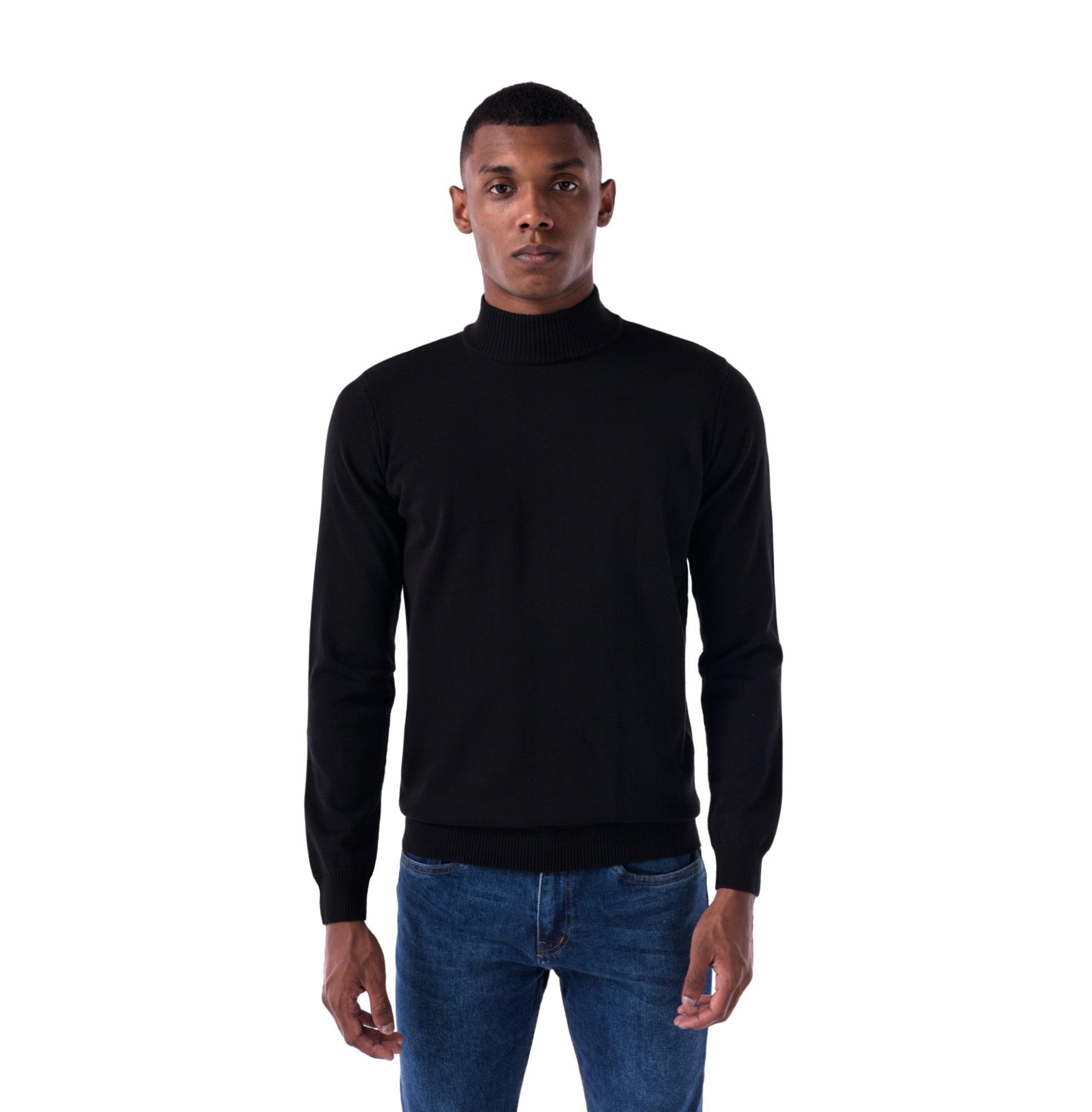 Man wearing a black turtleneck sweater and blue jeans on a white background