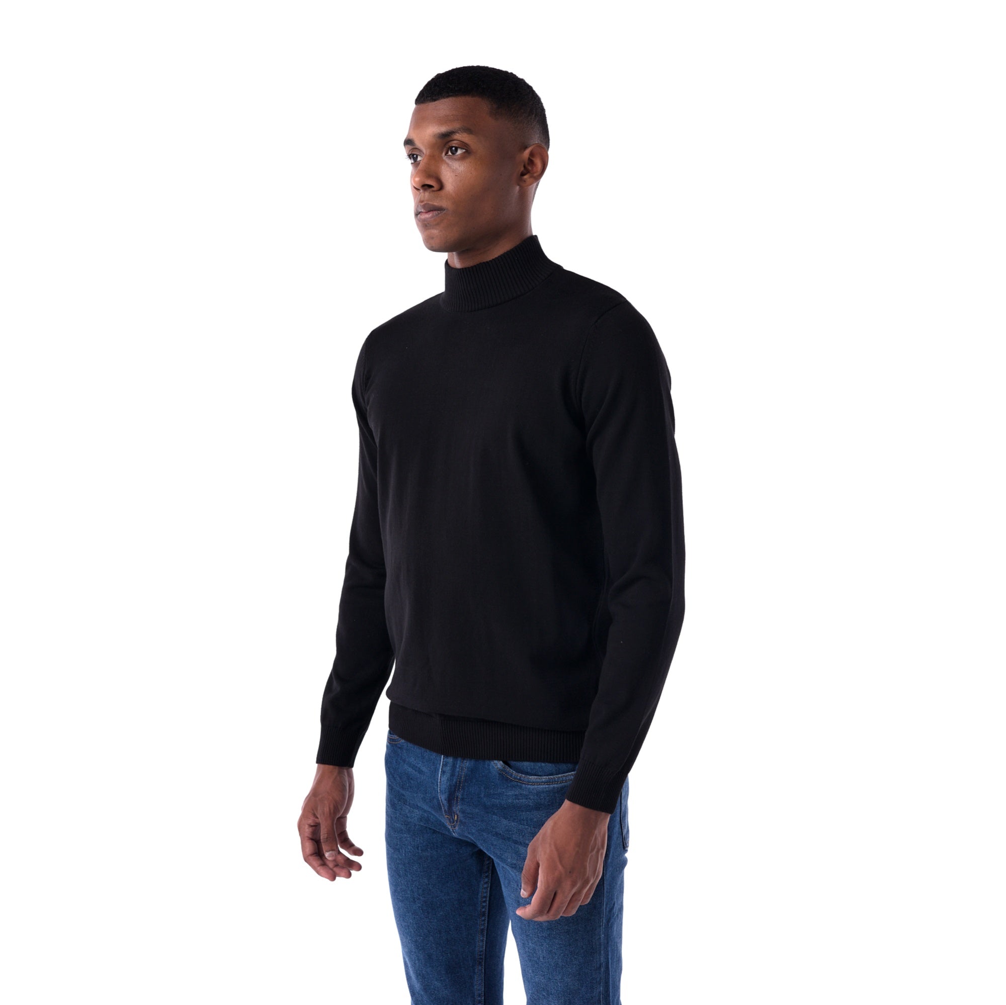 Man wearing a black turtleneck sweater and blue jeans on a white background