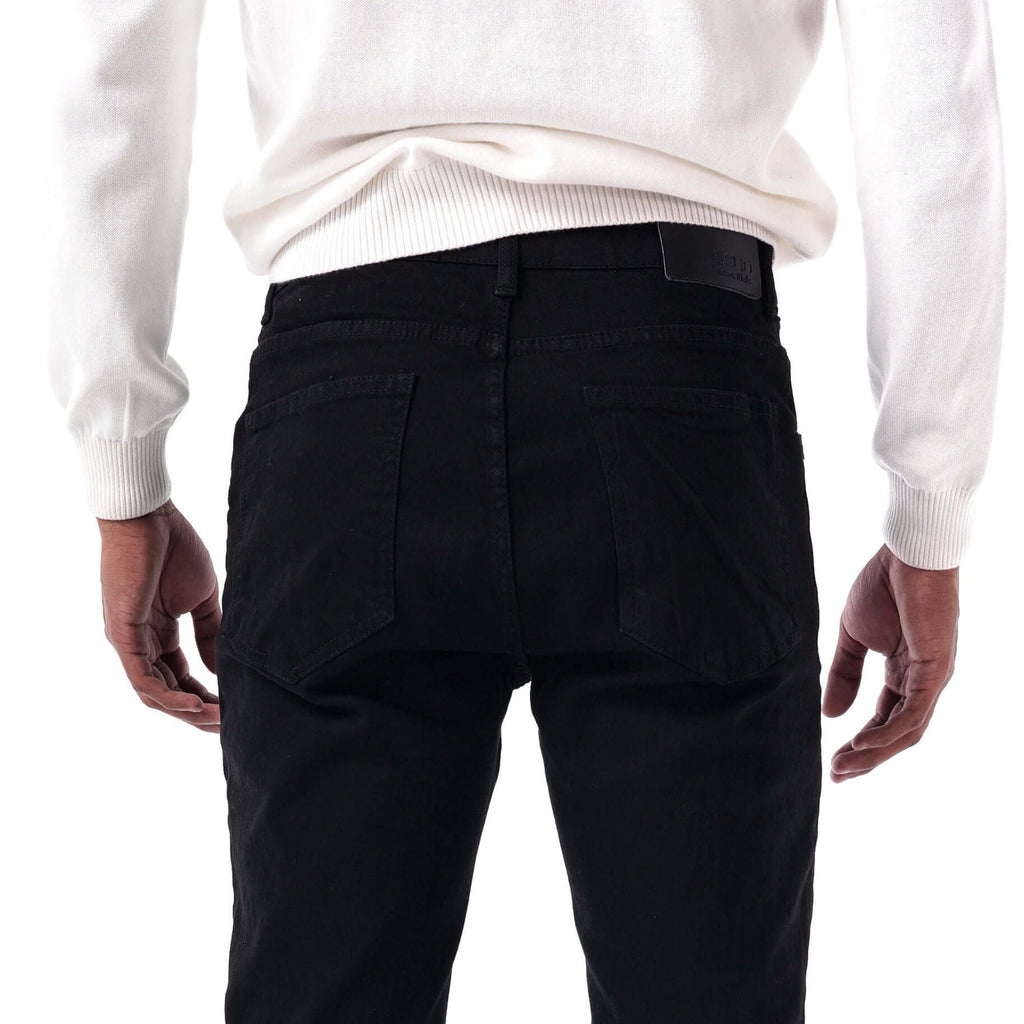 Person wearing black pants and a white sweater on a white background