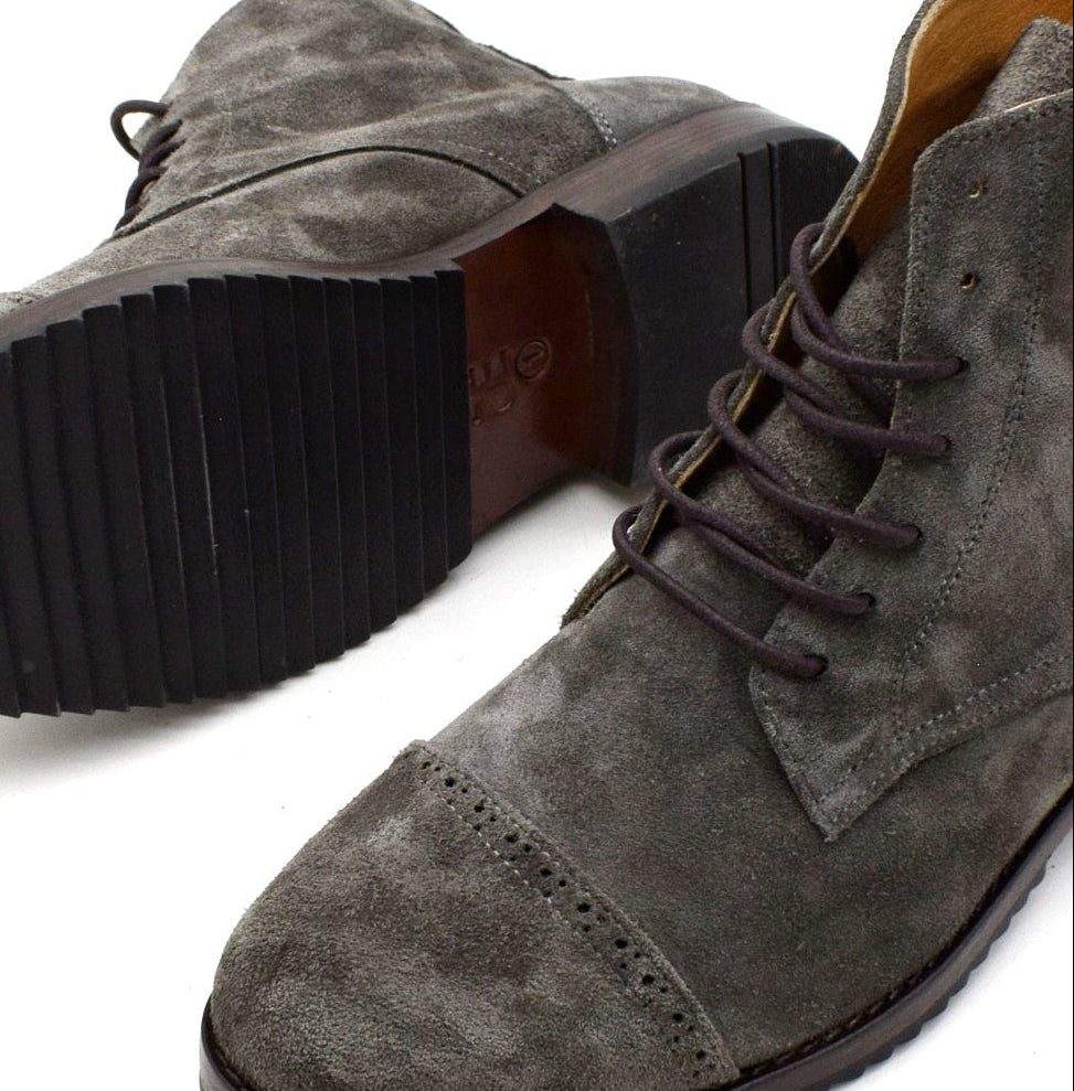 Gray suede boots leather sole on a white background