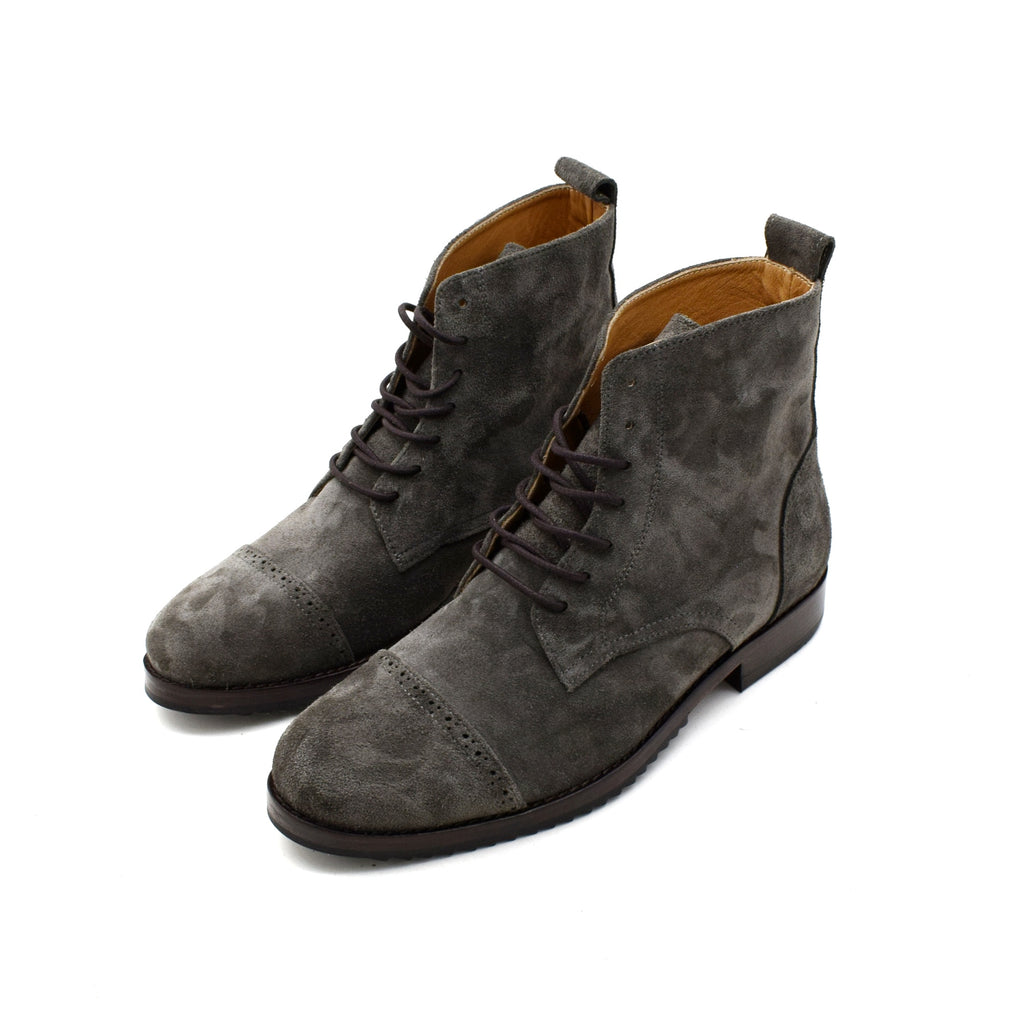 Pair of gray suede boots on a white background