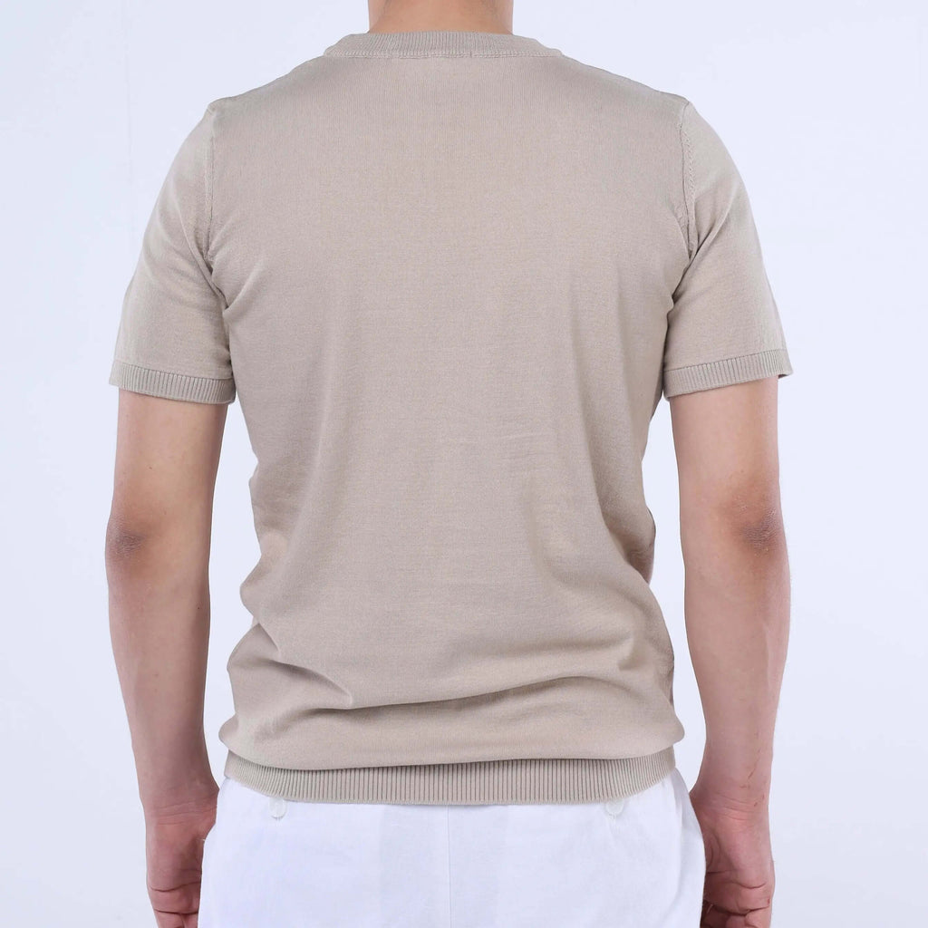 Back view of a man wearing a beige CloudKnit Crew Tee made from soft Egyptian cotton.