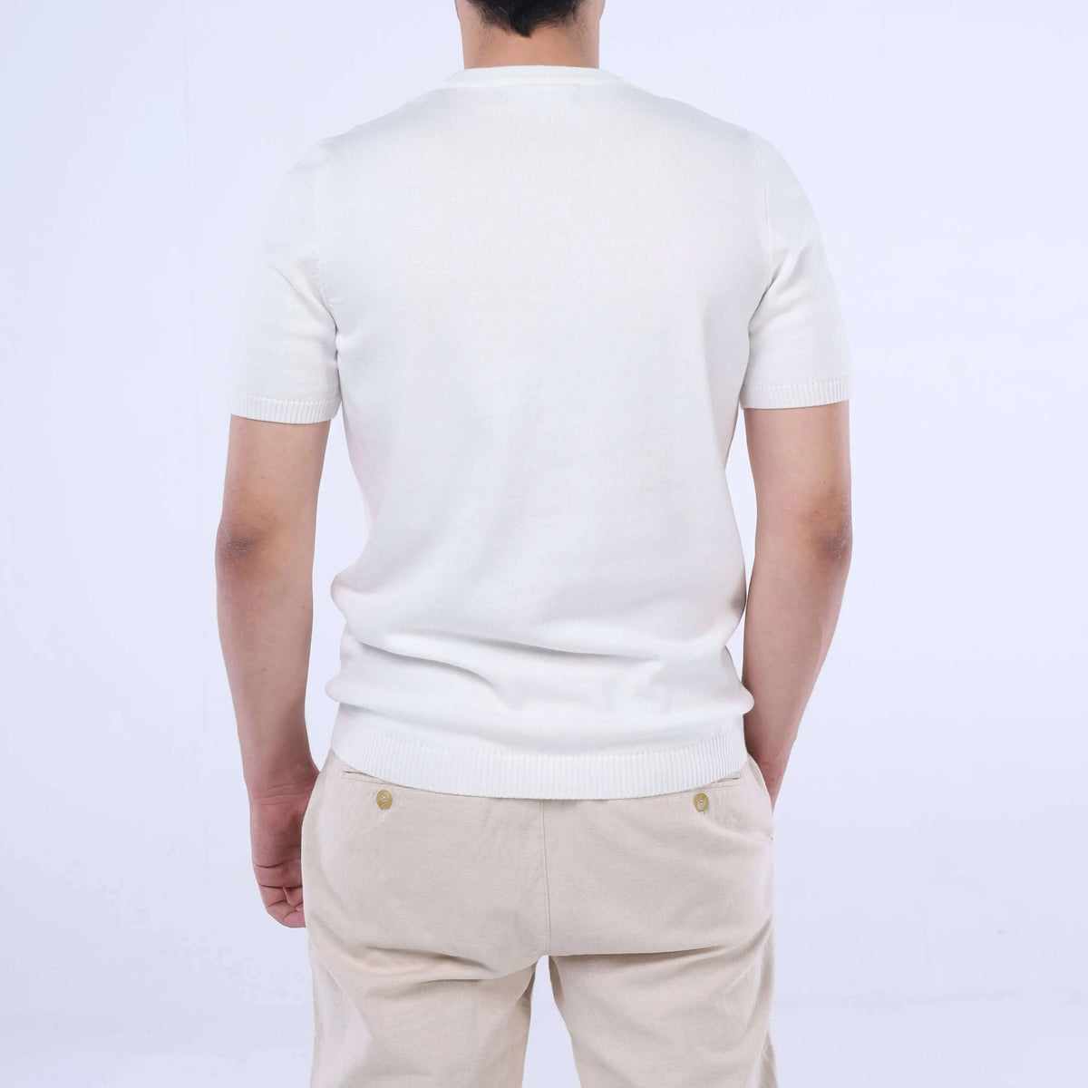 Back view of a man wearing a solid white CloudKnit Crew Tee crafted from ultra-soft Egyptian cotton.