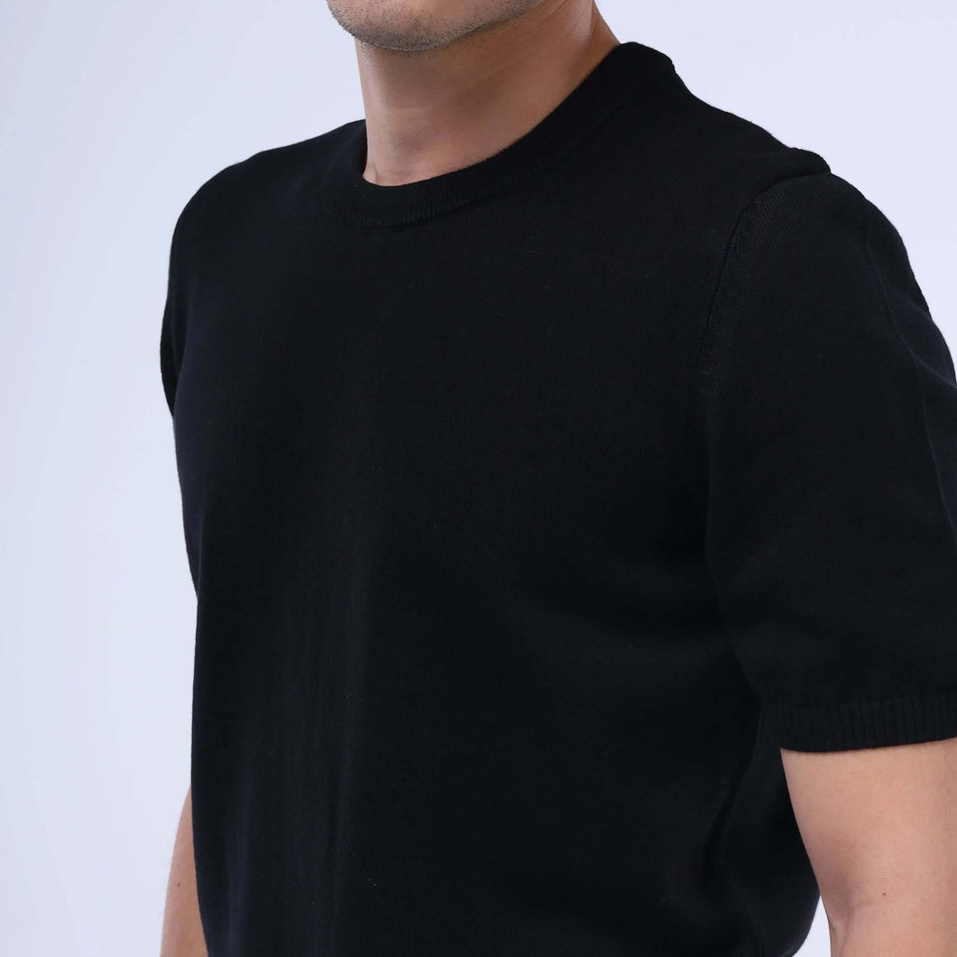 Man wearing a black CloudKnit Crew Tee made from ultra-soft Egyptian cotton for everyday luxury.