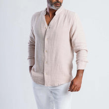 Load image into Gallery viewer, Collarless linen blend summer shirt in light beige worn by a man, showcasing modern, versatile style for warm weather.
