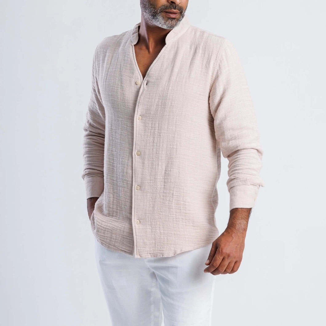 Collarless linen blend summer shirt in light beige worn by a man, showcasing modern, versatile style for warm weather.
