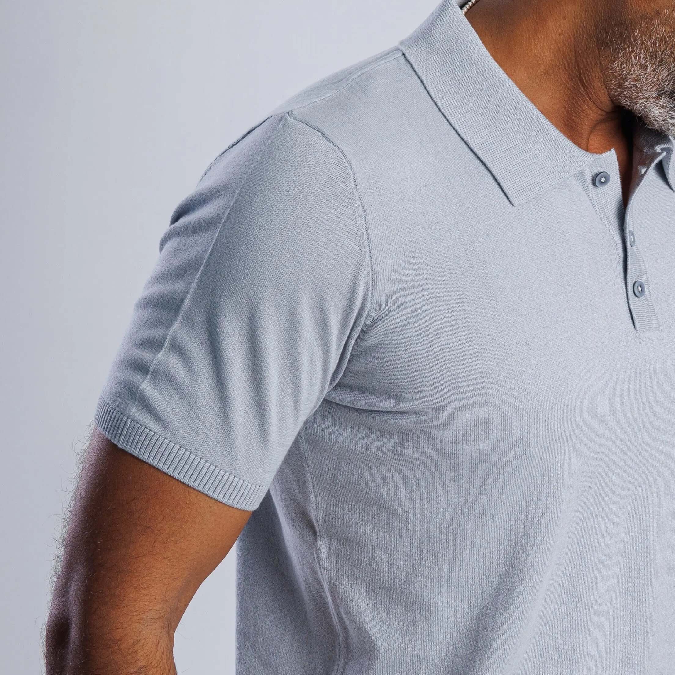 Man wearing a light blue ComfortLite™ Knit Polo showcasing its breathable fabric and stylish design.