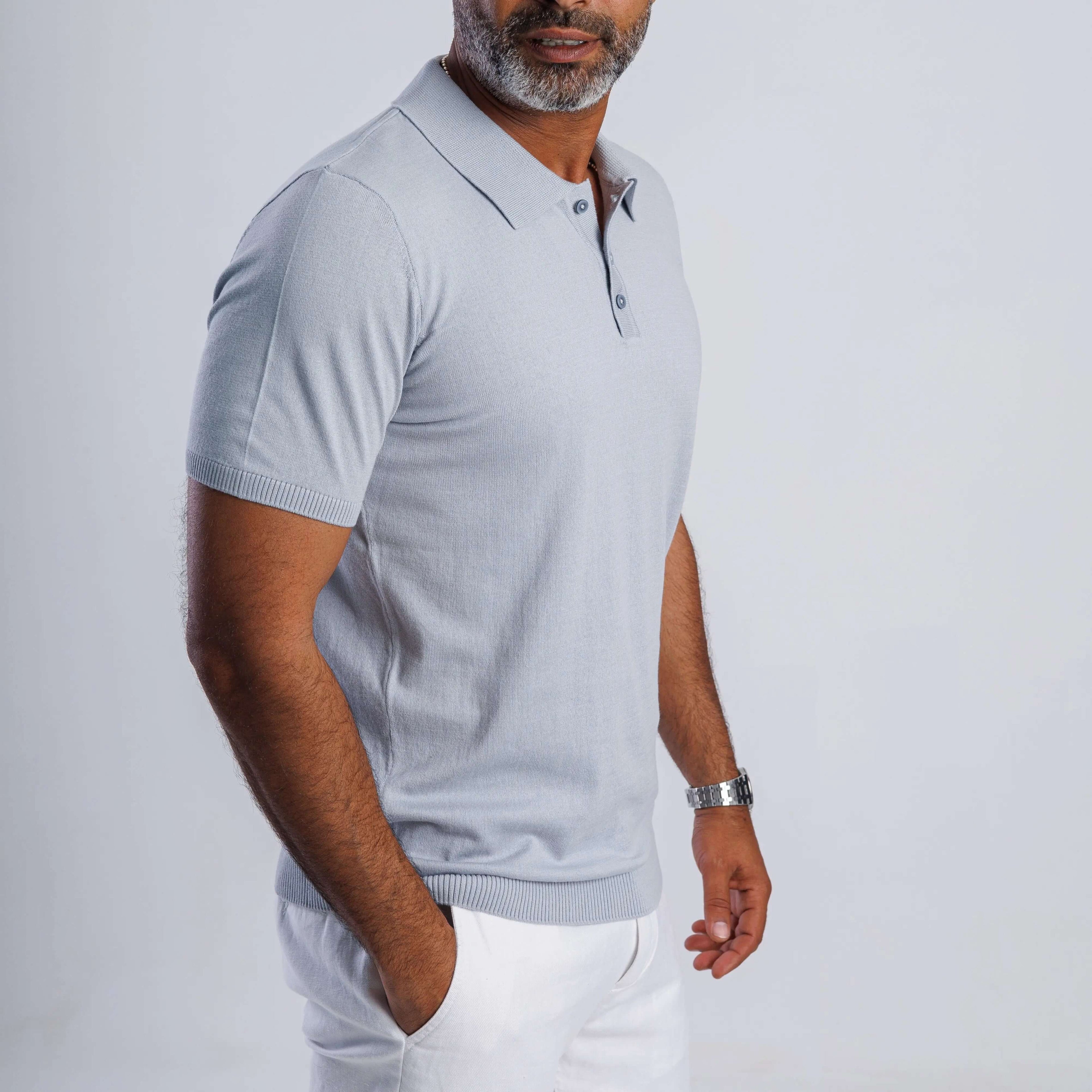 Man wearing a light blue ComfortLite™ Knit Polo, showcasing a stylish and breathable design for all-season comfort.