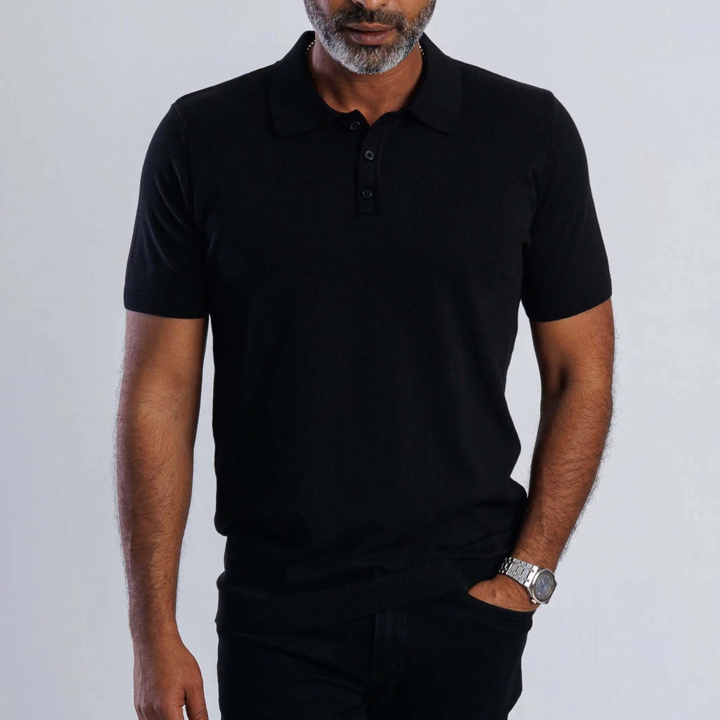 Model wearing a black ComfortLite™ Knit Polo, showcasing its stylish design and breathable fabric.