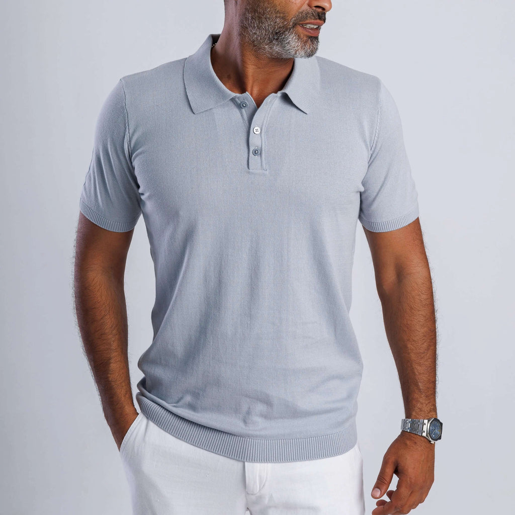 Man wearing a light grey ComfortLite™ Knit Polo, showcasing its sleek design and breathable fabric.