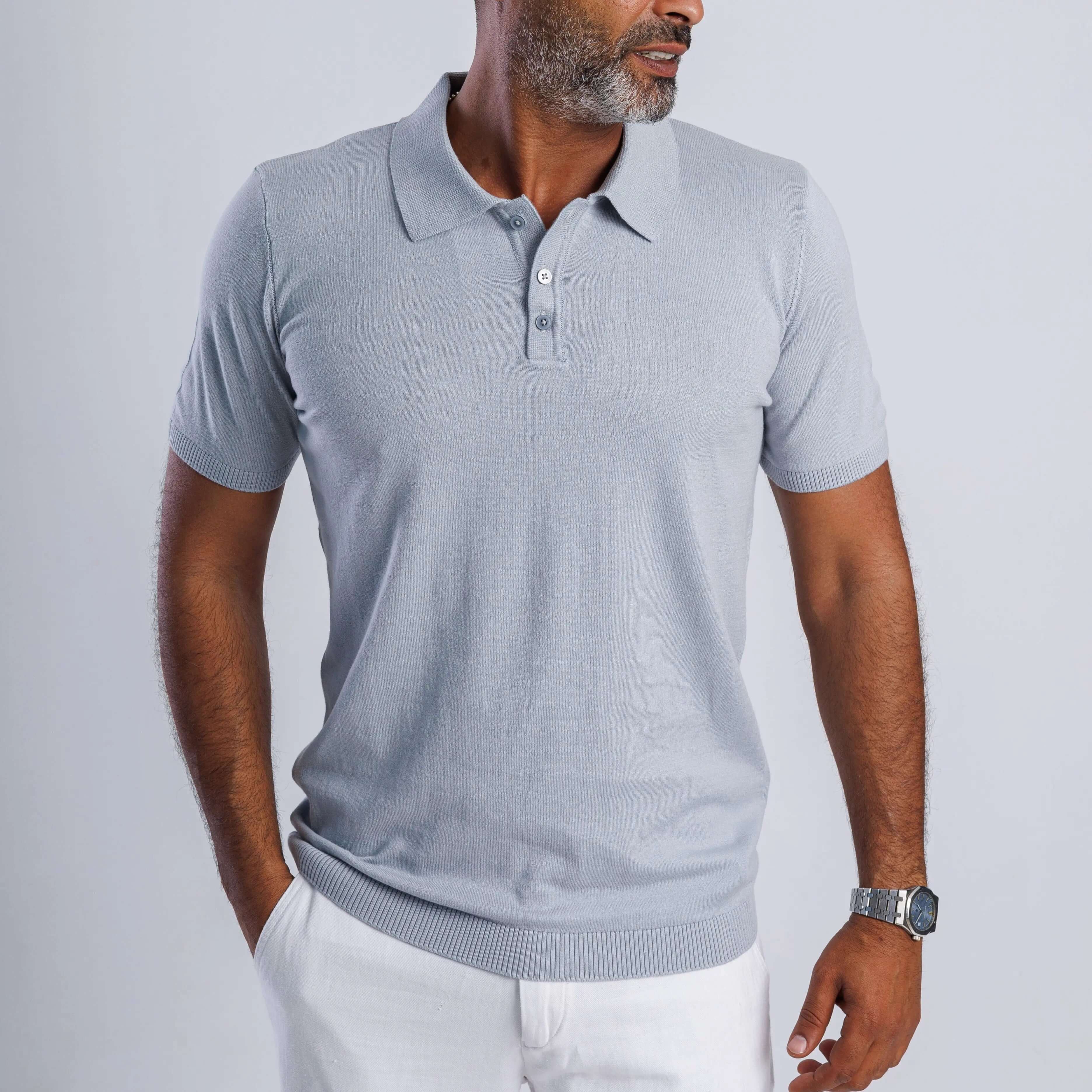 Man wearing a light grey ComfortLite™ Knit Polo, showcasing its sleek design and breathable fabric.