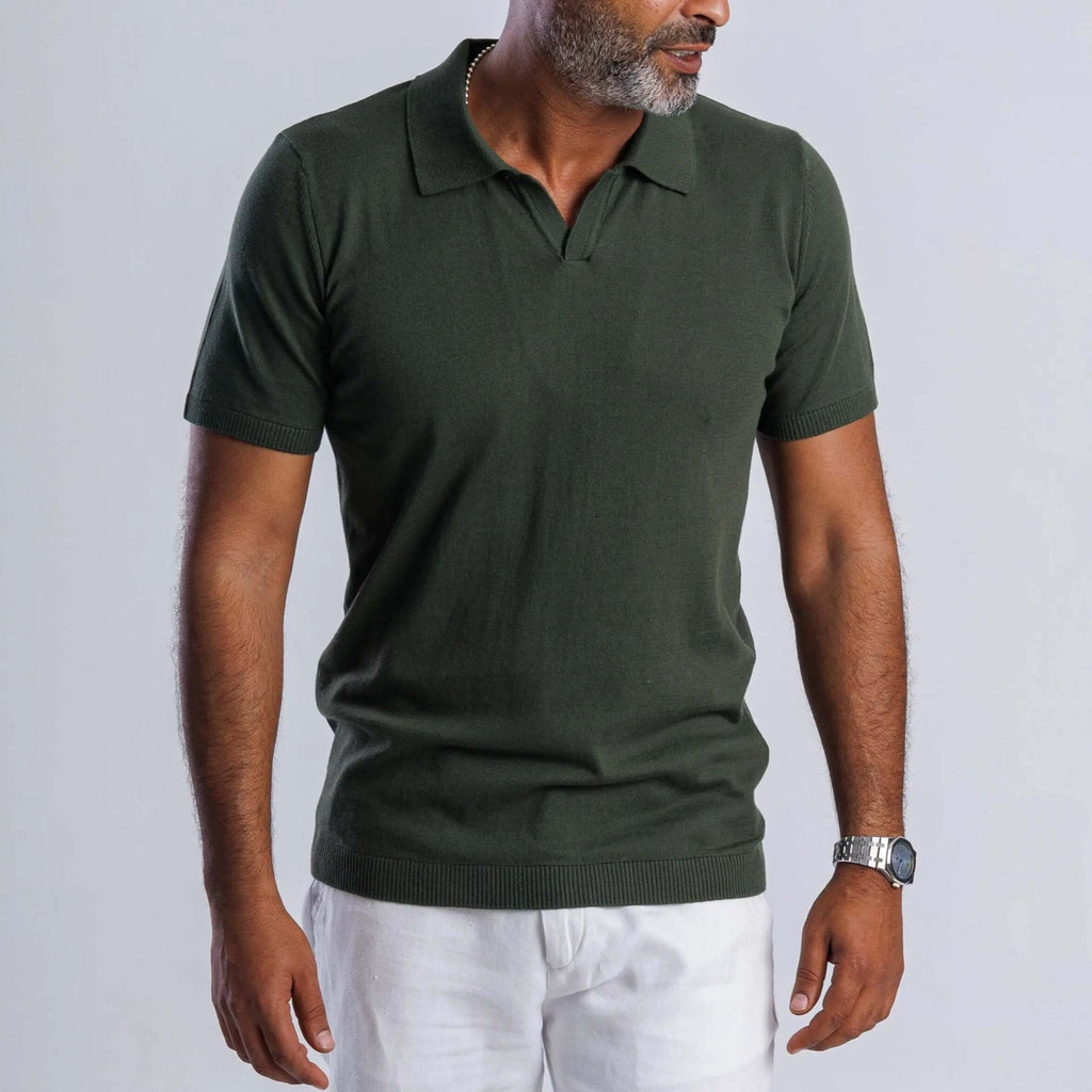 Man wearing a green FlowKnit™ Relaxed V-Neck shirt with short sleeves and a casual style.