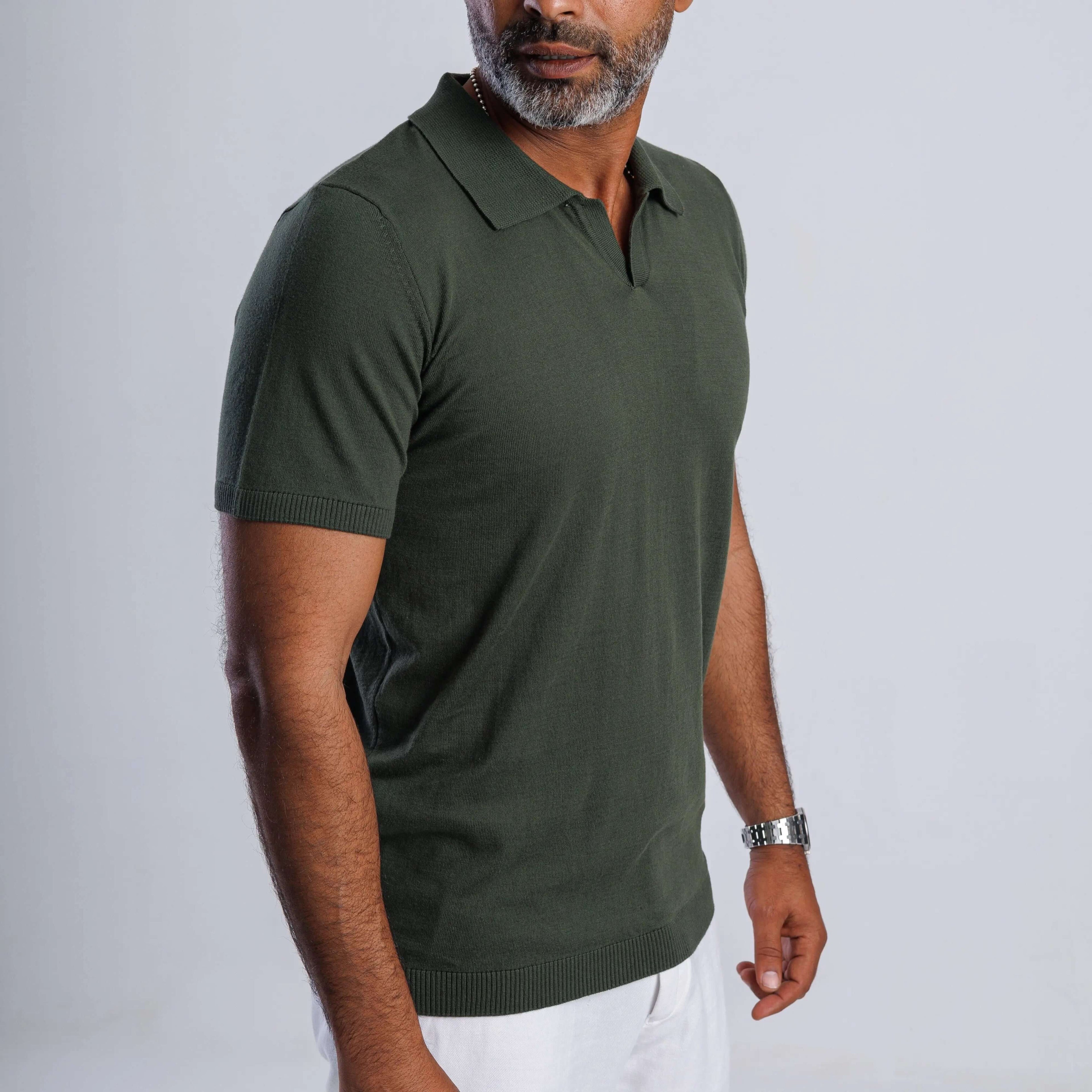 Man in green FlowKnit Relaxed V-Neck shirt, showcasing minimalist style and comfort.