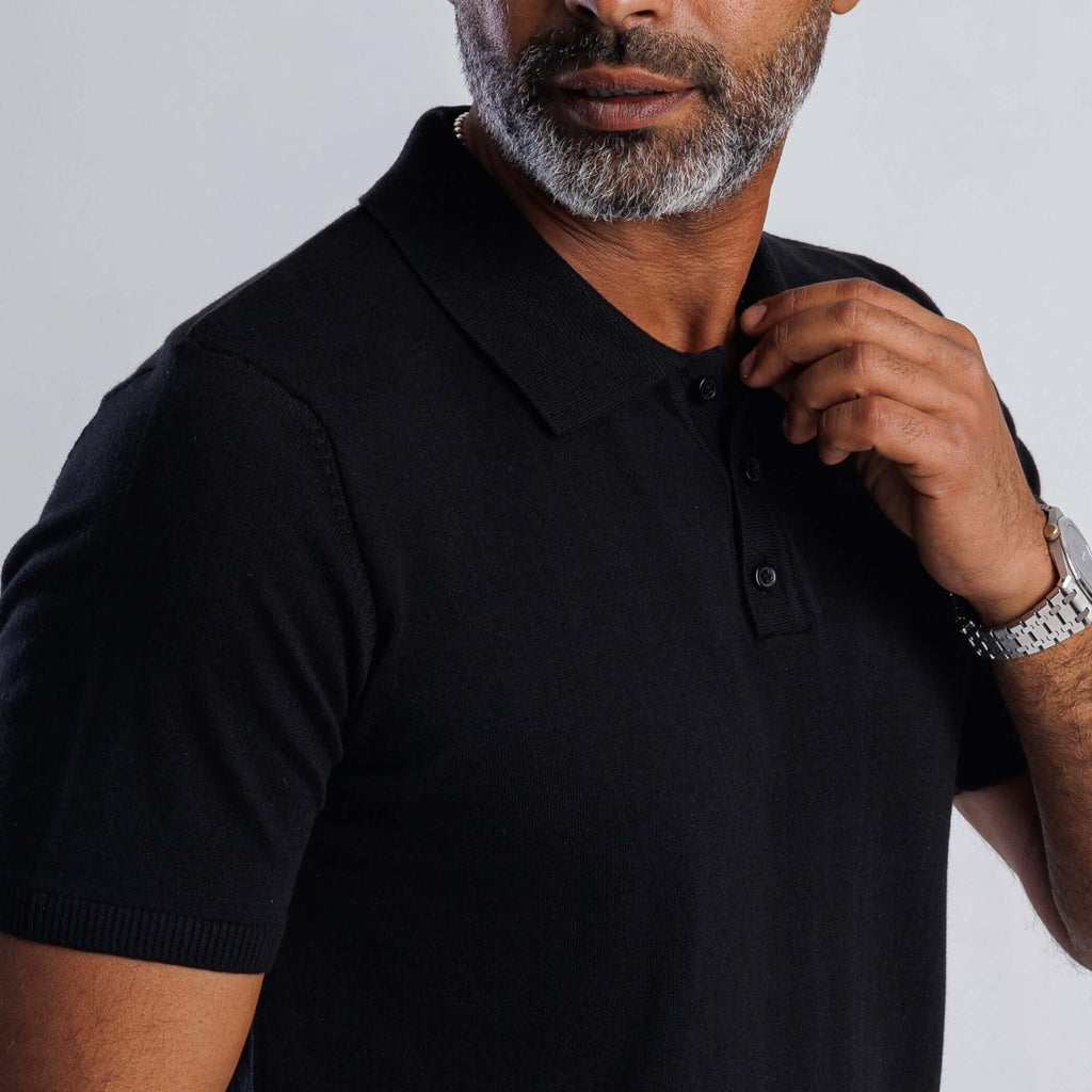 Man wearing a black ComfortLite™ Knit Polo, showcasing lightweight style and all-day comfort.