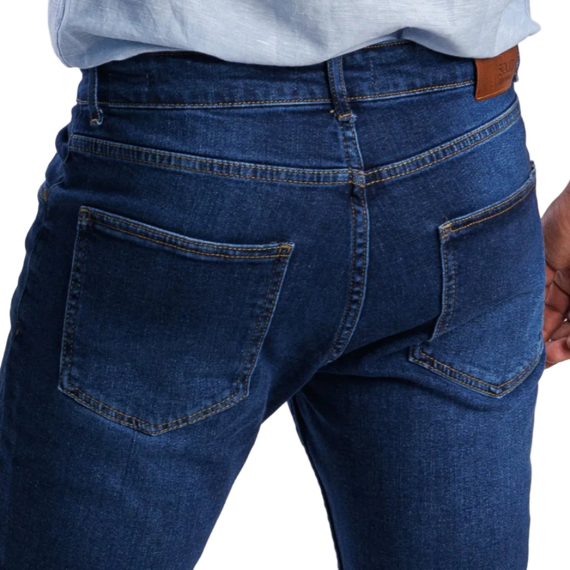 Blue jeans worn by a person on a white background