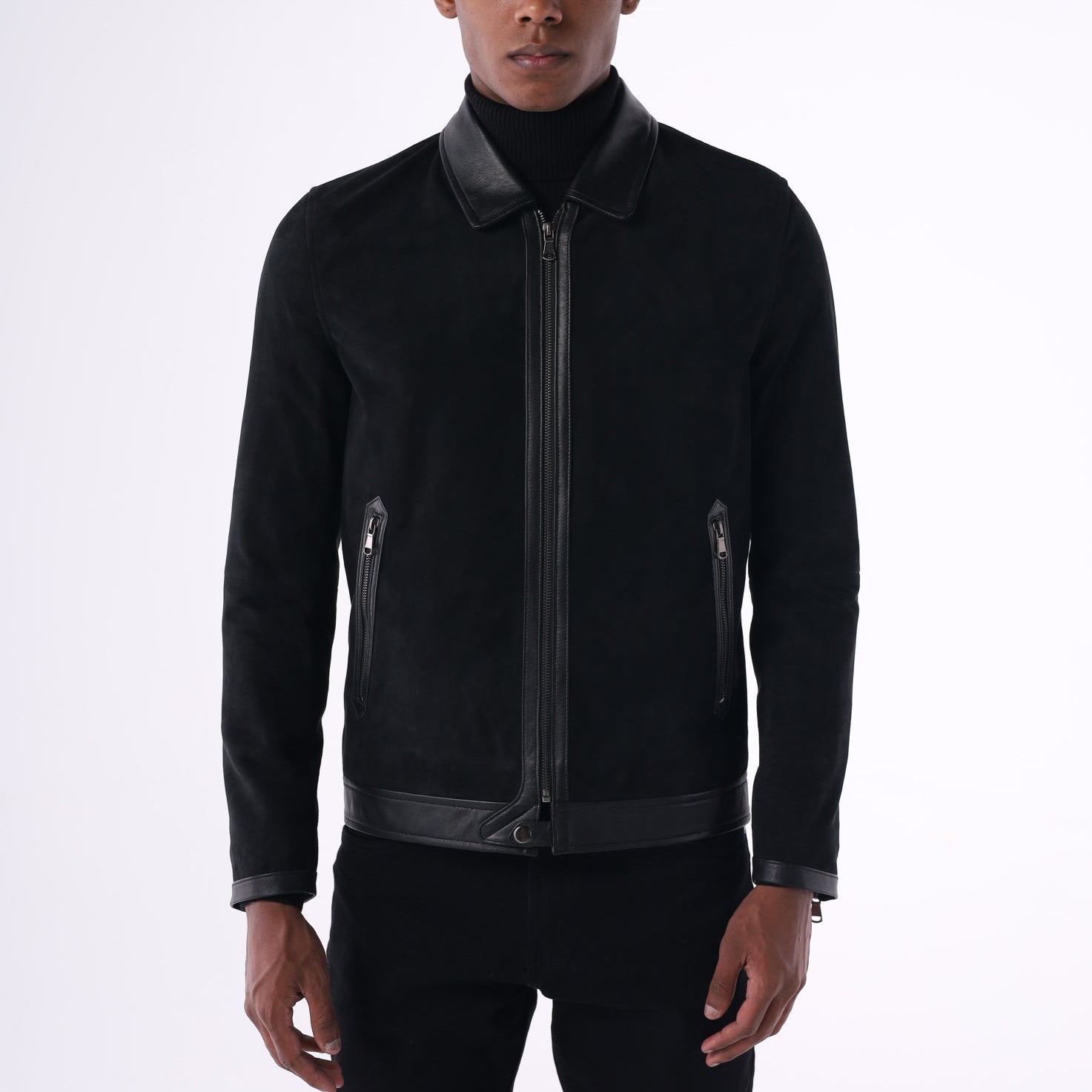 Person wearing a black jacket with reflective stripes on a white background