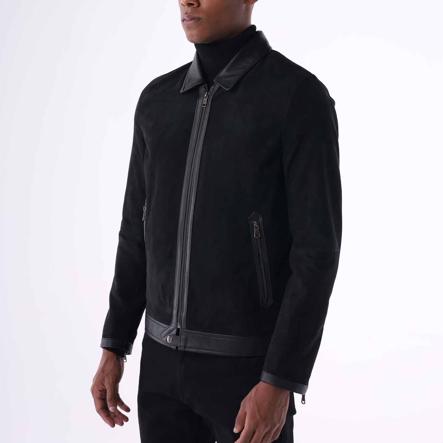 Person wearing a black jacket with zippers on a white background