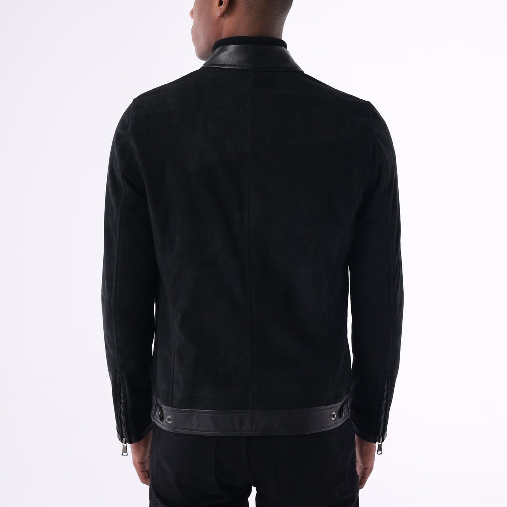 Person wearing a black outfit with a clear plastic bag over their head on a white background