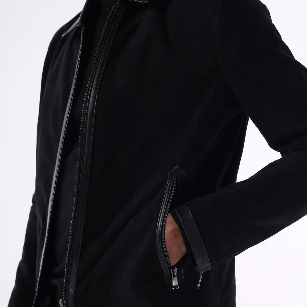 Person wearing a black jacket with a white background