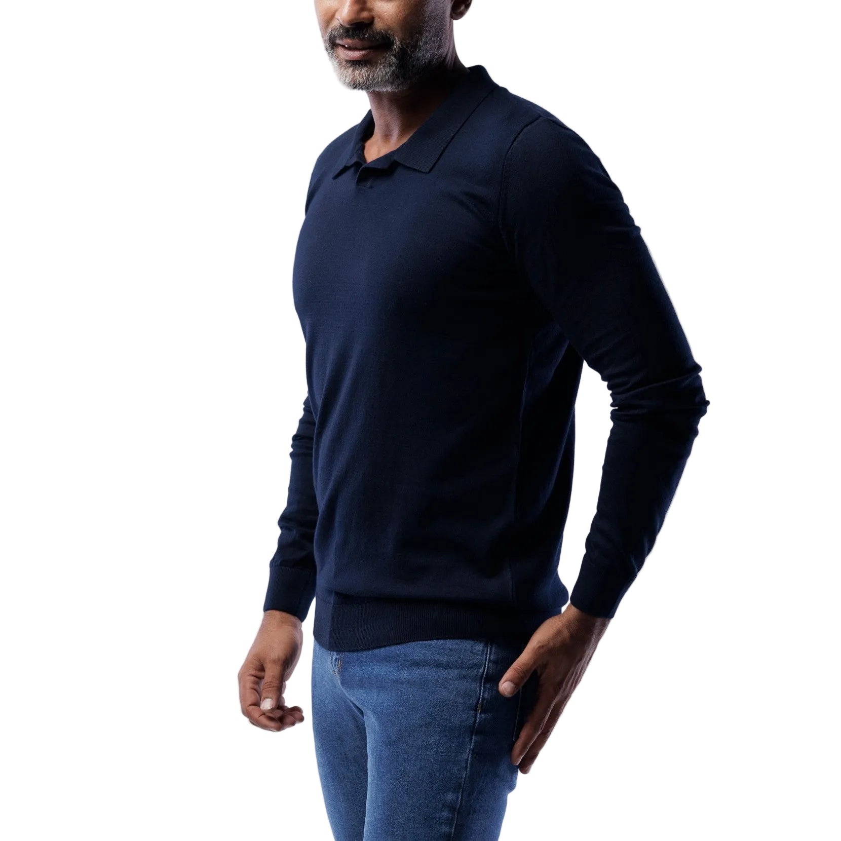 Man wearing a navy long-sleeve shirt and blue jeans on a light gray background