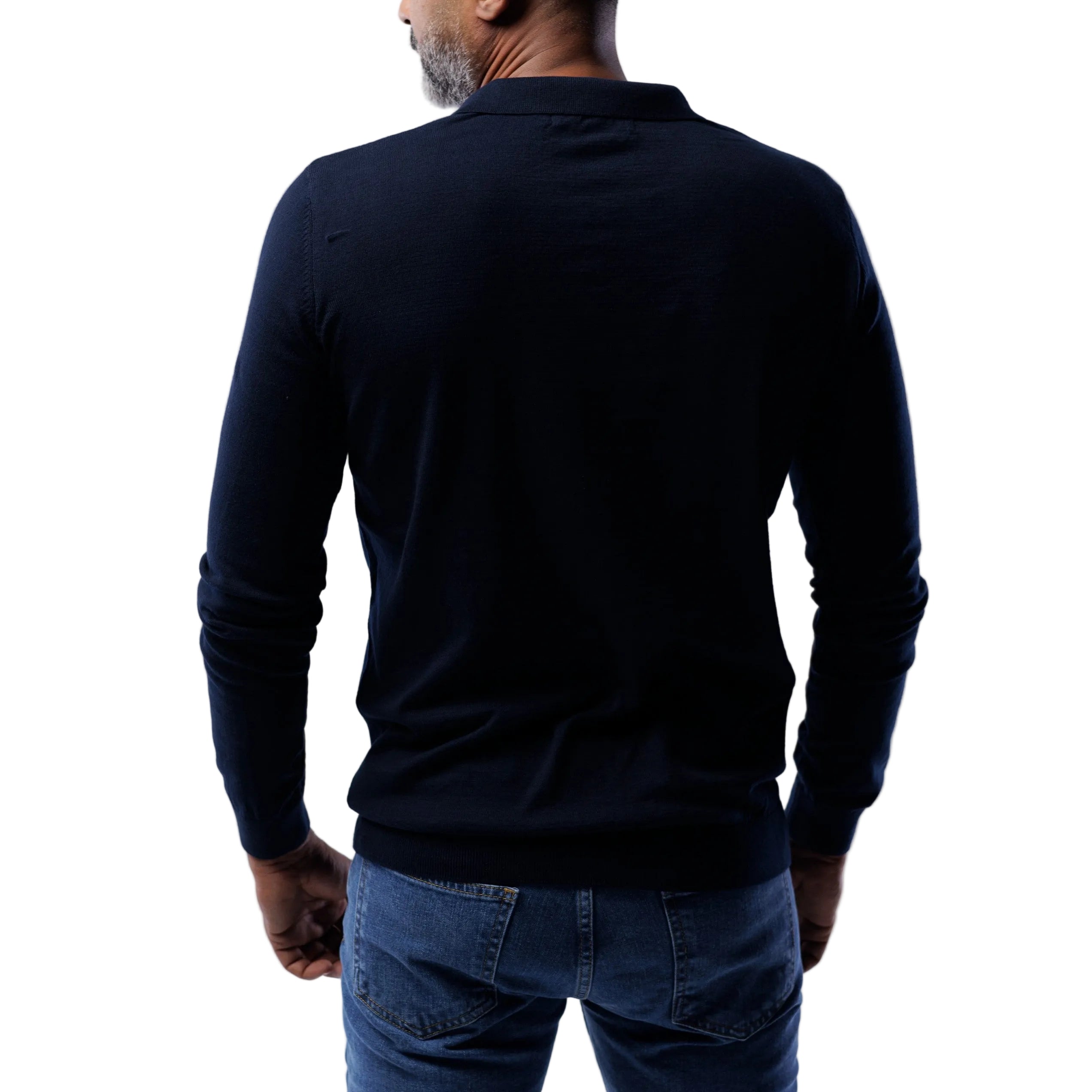 Person wearing a dark long-sleeve shirt and blue jeans on a white background
