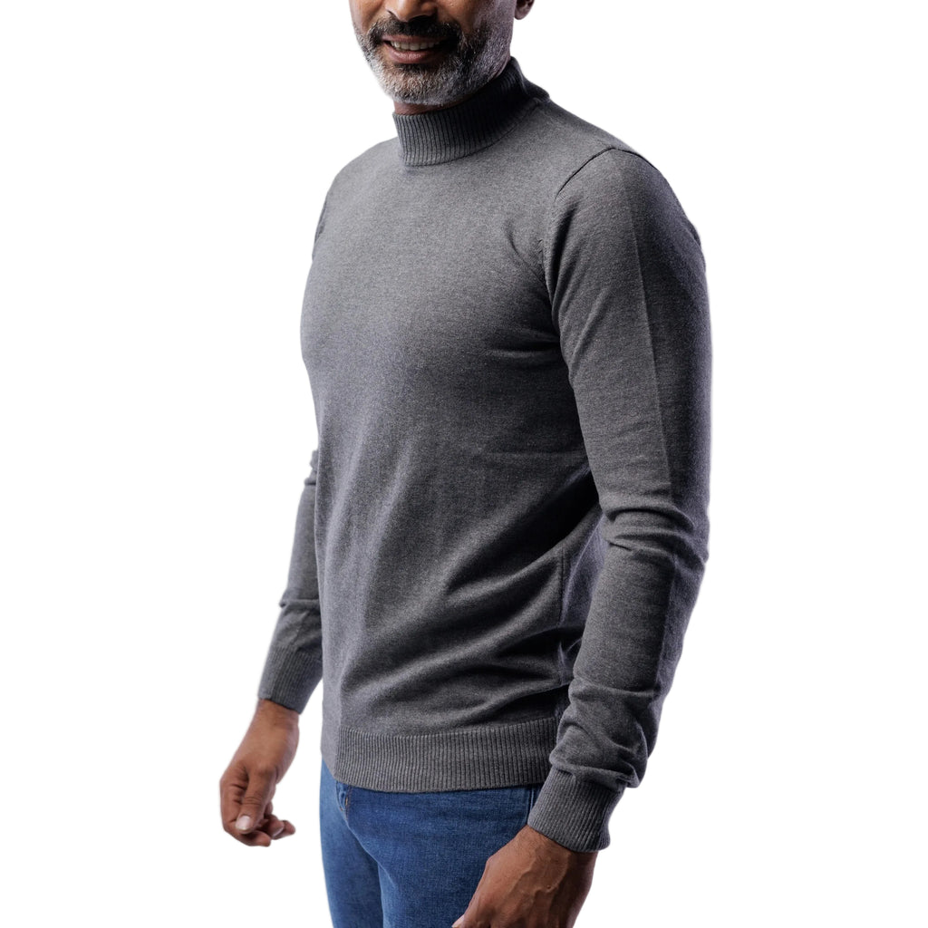Man wearing a gray turtleneck sweater against a white background