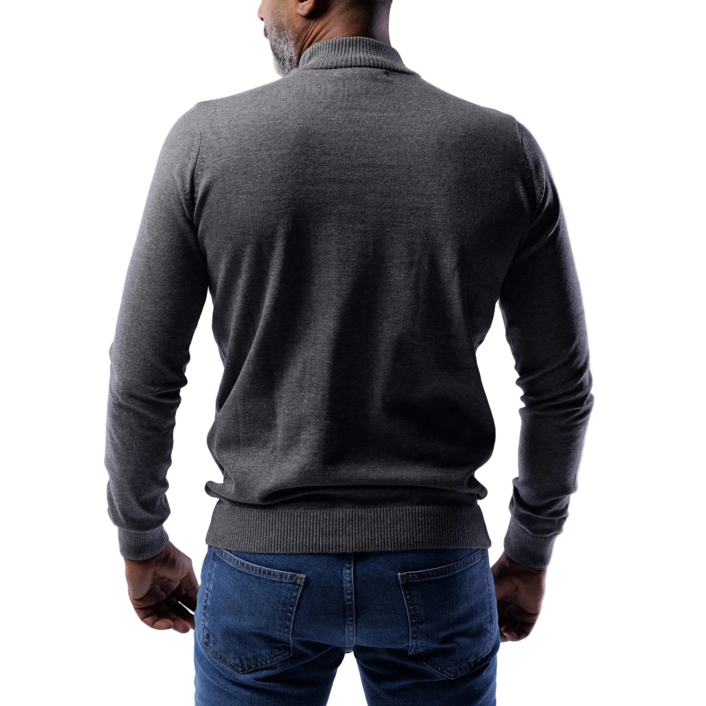 Man wearing a gray sweater and blue jeans on a white background