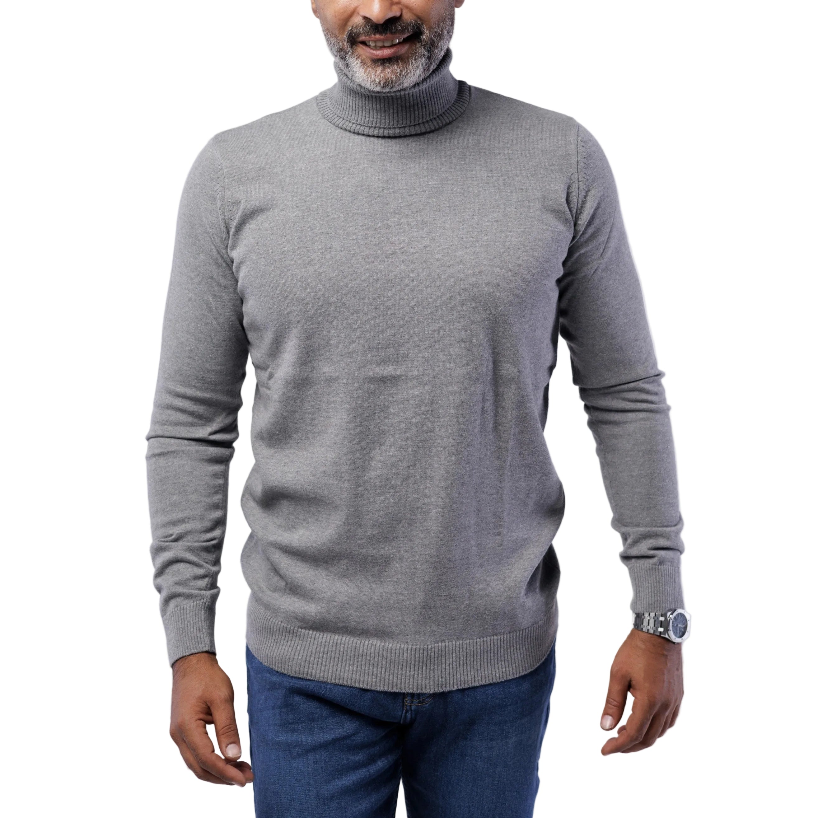 Man wearing a gray turtleneck sweater and blue jeans on a light gray background
