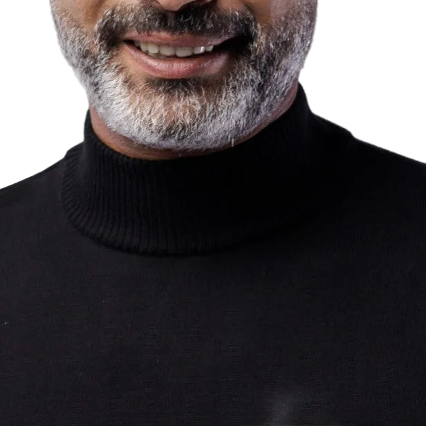 Man wearing a black turtleneck sweater against a white background