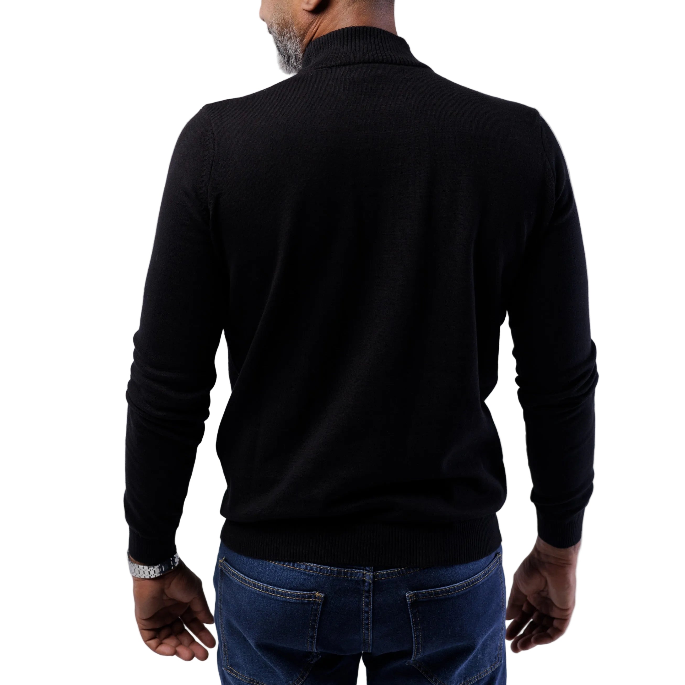 Person wearing a black long-sleeve shirt and blue jeans on a white background