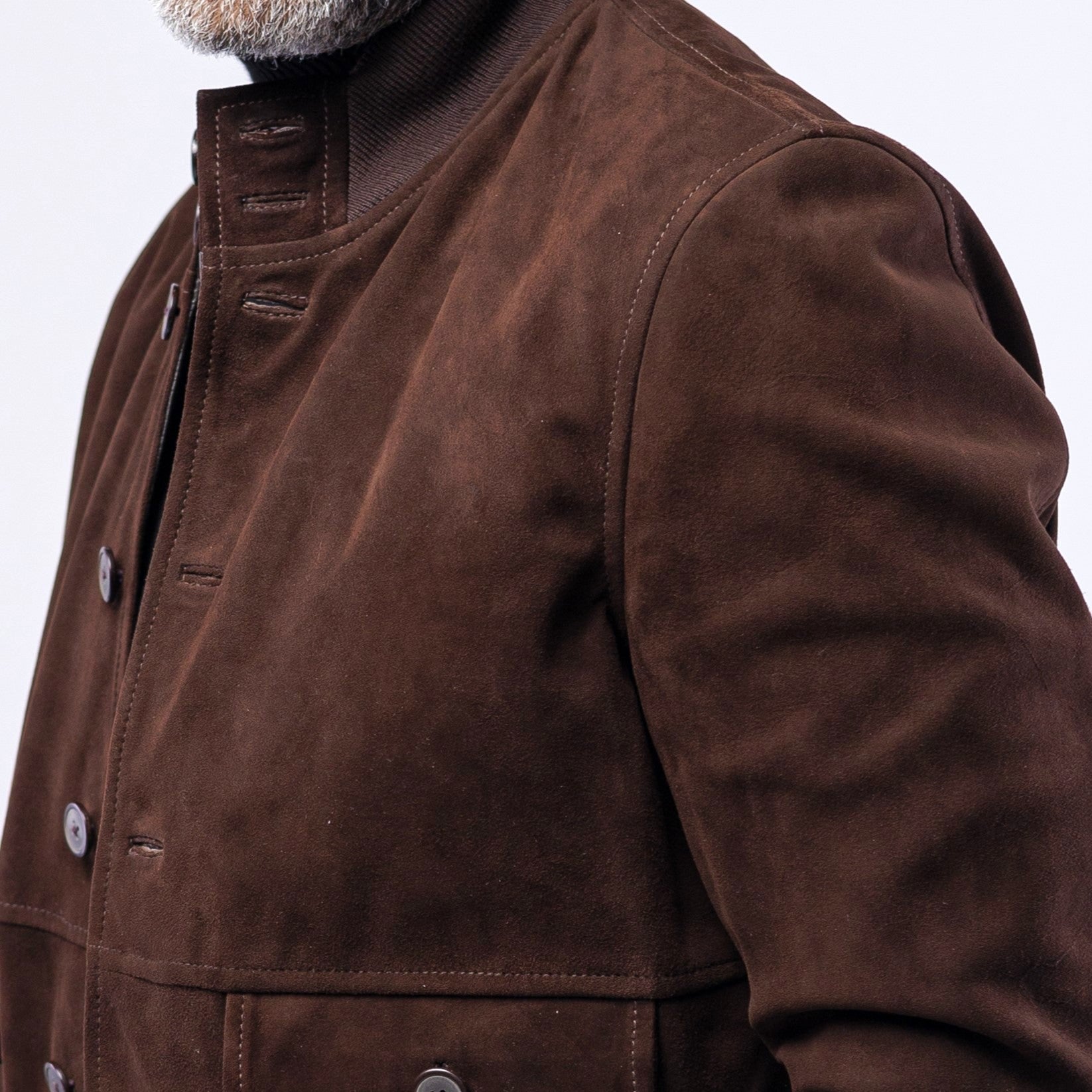 Close-up of a brown leather jacket on a white background