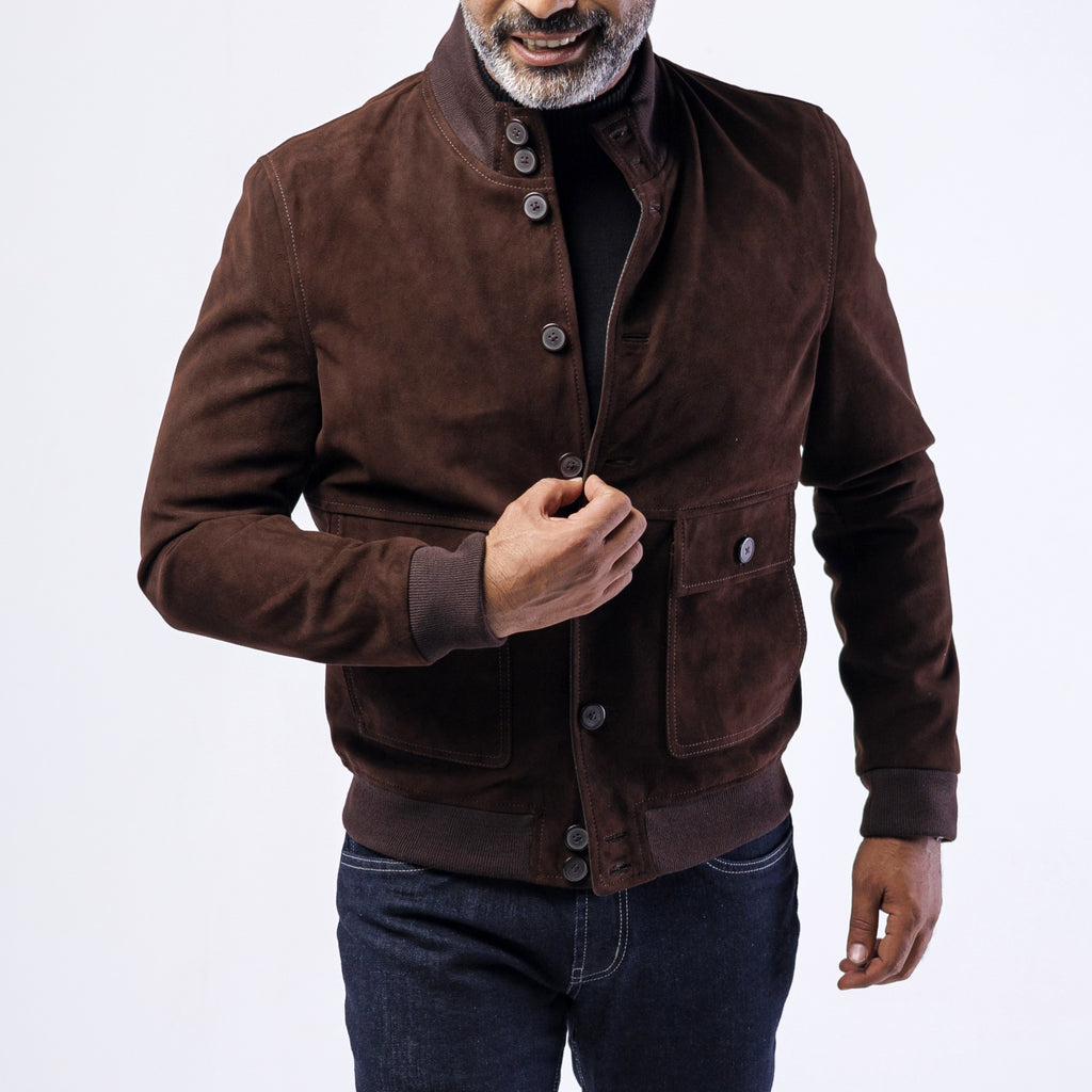 Man wearing a brown suede jacket on a white background