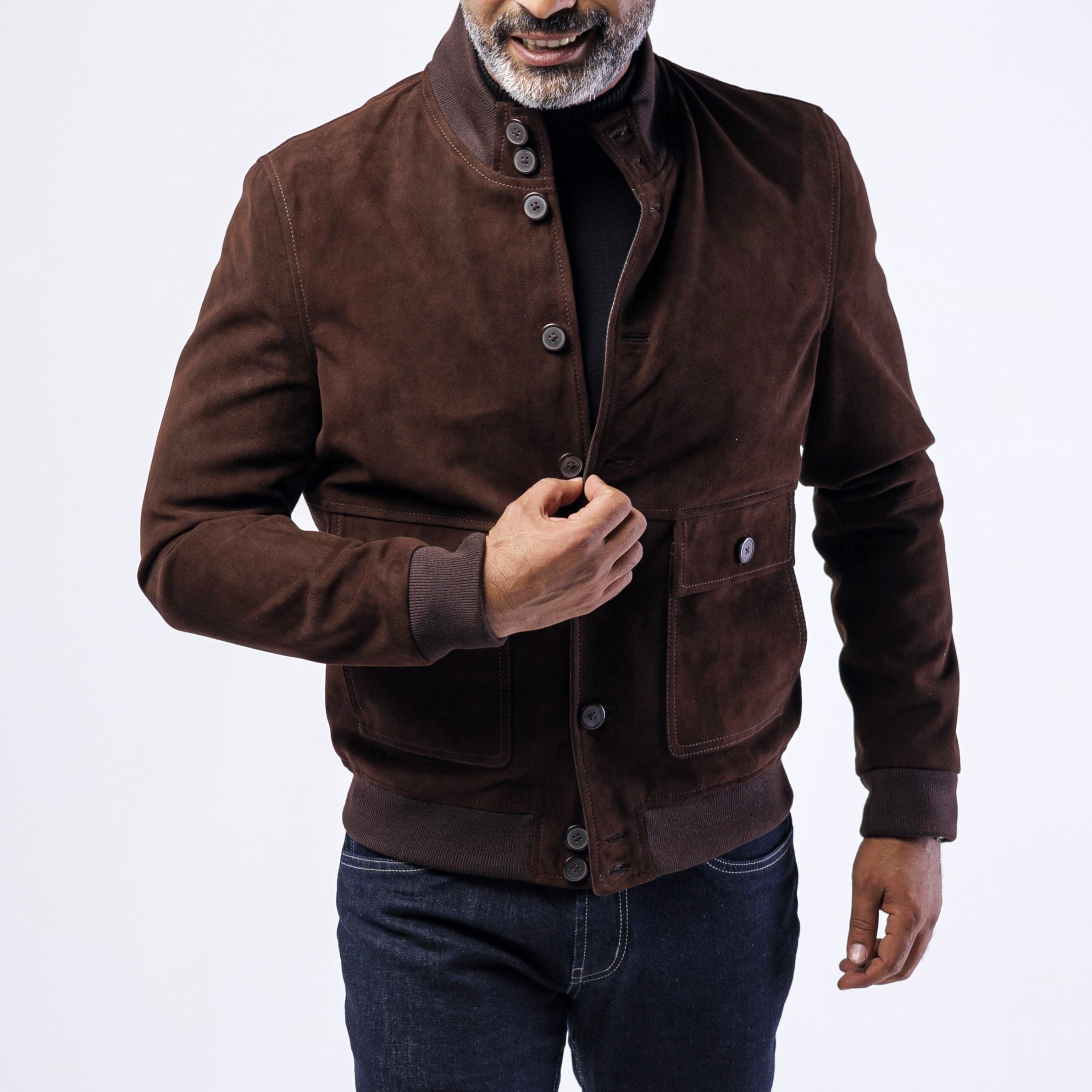 Man wearing a brown suede jacket on a white background