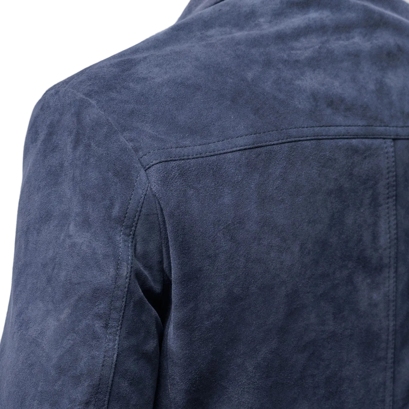 Close-up of a blue denim jacket on a plain background