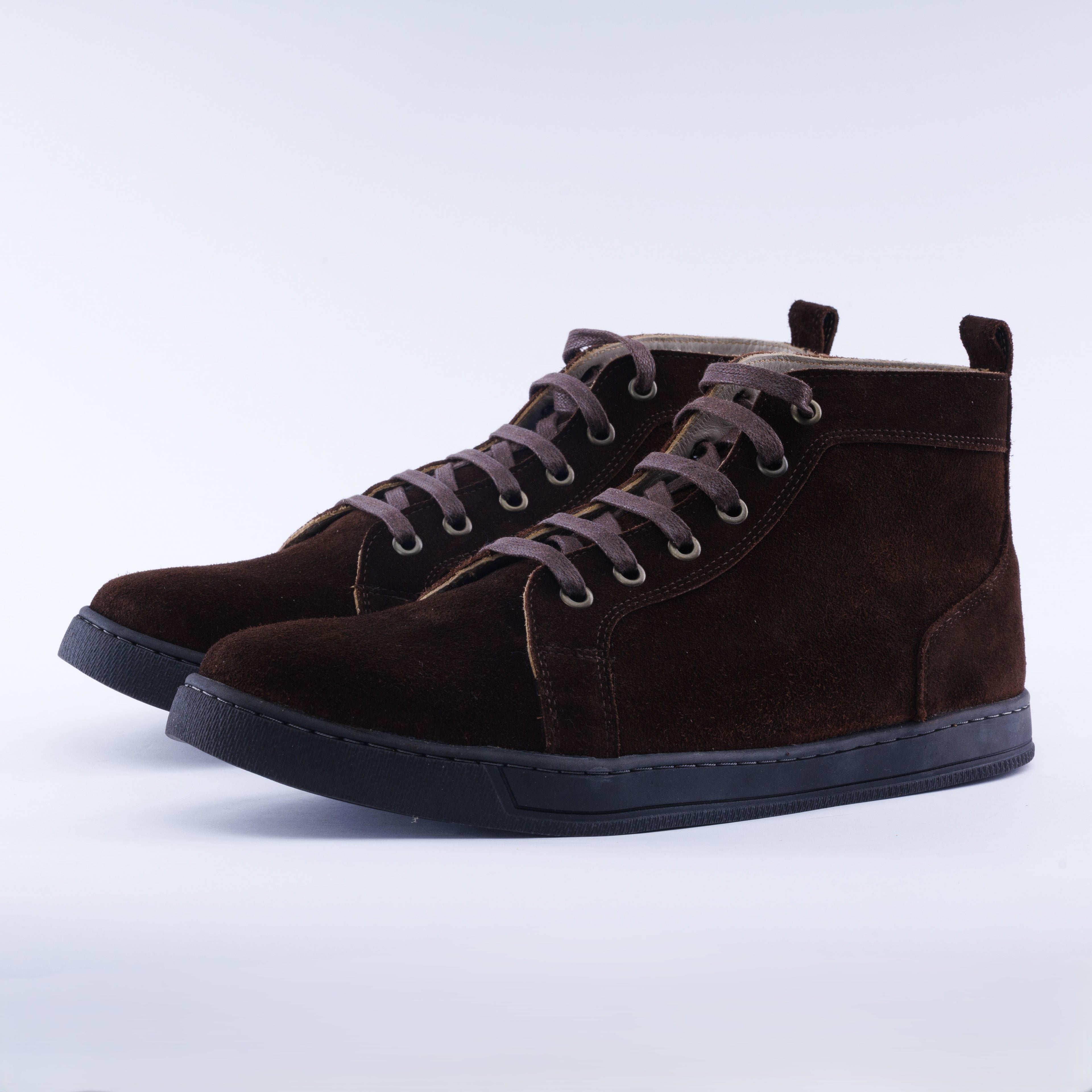 A pair of dark brown suede high-top sneakers with matching laces and black soles, photographed on a clean white studio background.
