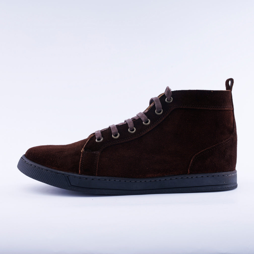 A dark brown suede high-top sneaker boot with matching brown laces and a black sole, shown in a side profile on a light gray background.