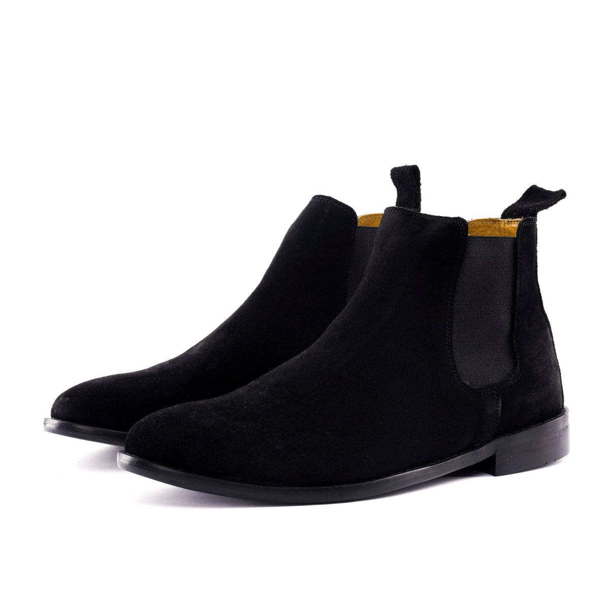 A pair of black suede Chelsea boots with black elastic side panels, shown from a side profile view on a clean white background.