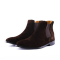 A pair of dark brown suede Chelsea boots with elastic side panels, shown on a clean white background.
