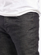 Load image into Gallery viewer, Dark gray jeans worn by a person on a white background
