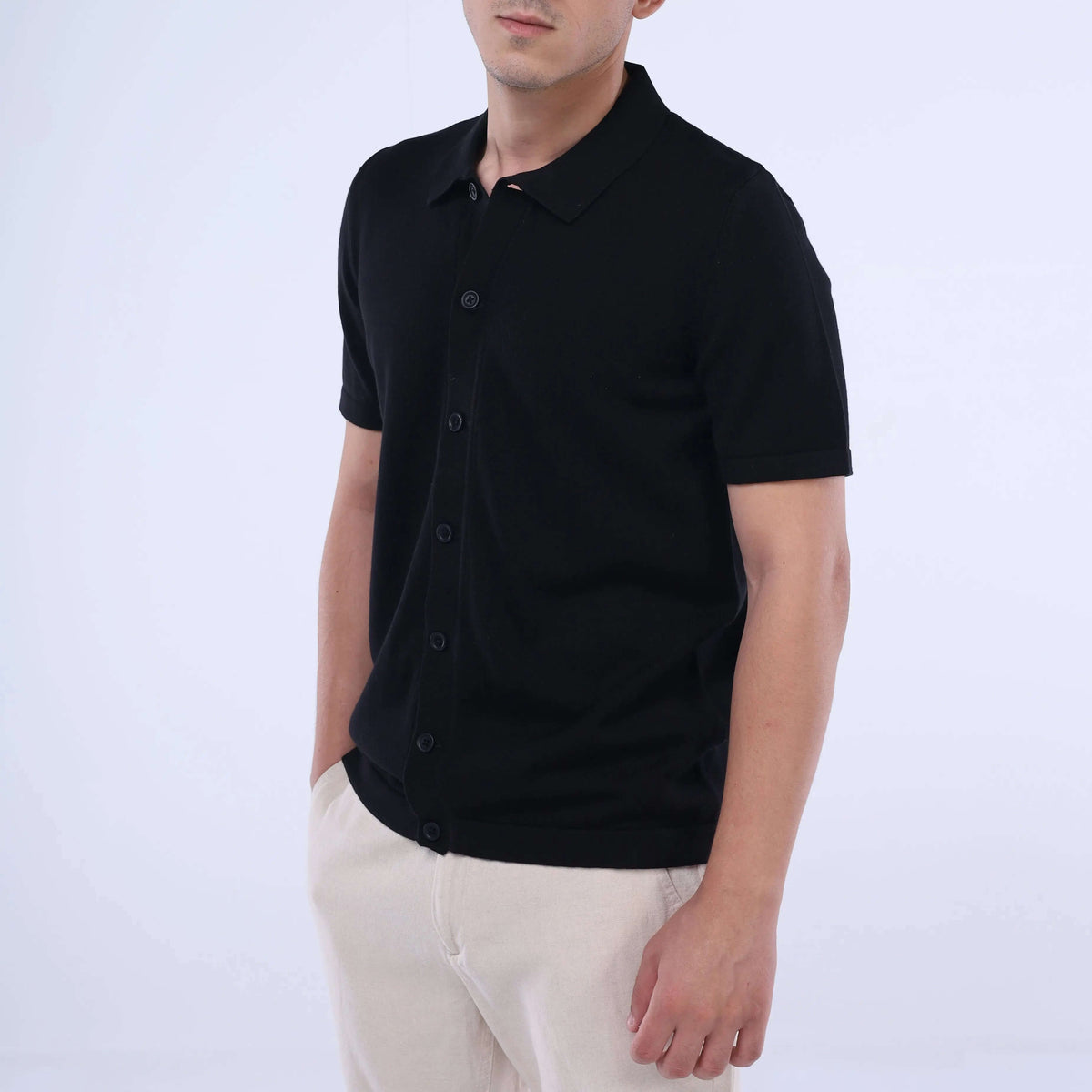Model wearing a black solid Knit-Layer™ Short Sleeve Shirt, showcasing its versatile style and lightweight fabric.