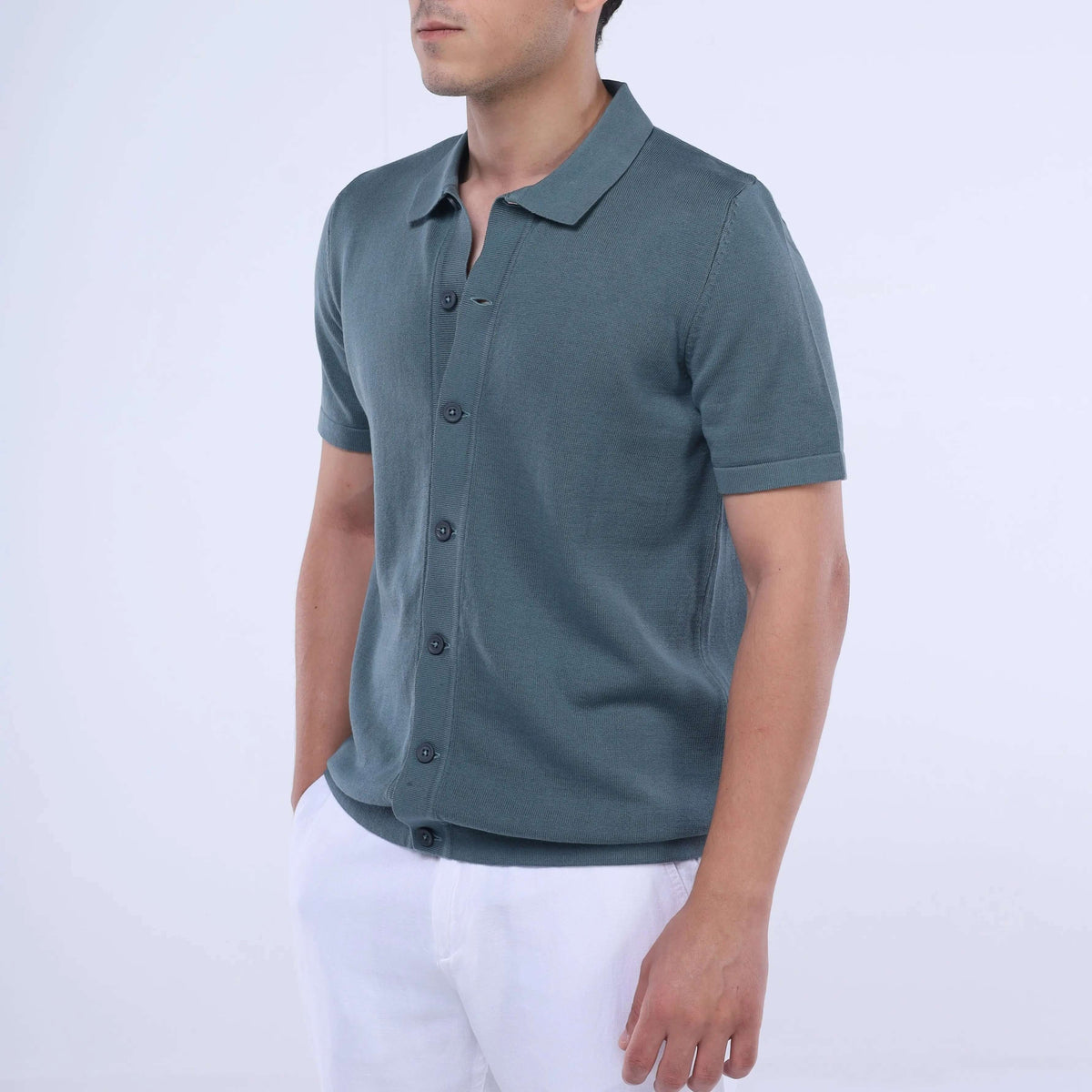 Stylish model wearing a Knit-Layer™ Short Sleeve Shirt in teal, showcasing versatile summer fashion.