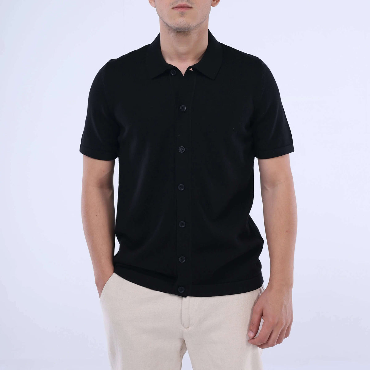 Model wearing solid black Knit-Layer™ short sleeve shirt, showcasing its versatile and breathable design.