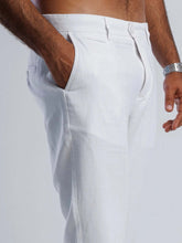 Load image into Gallery viewer, Close-up of linen blend tapered trousers showcasing the tailored fit and side pockets, perfect for breathable comfort.
