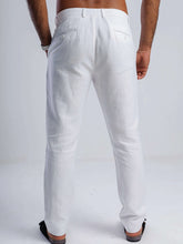 Load image into Gallery viewer, White linen blend tapered trousers showing the back view, featuring discreet pockets and tailored fit.
